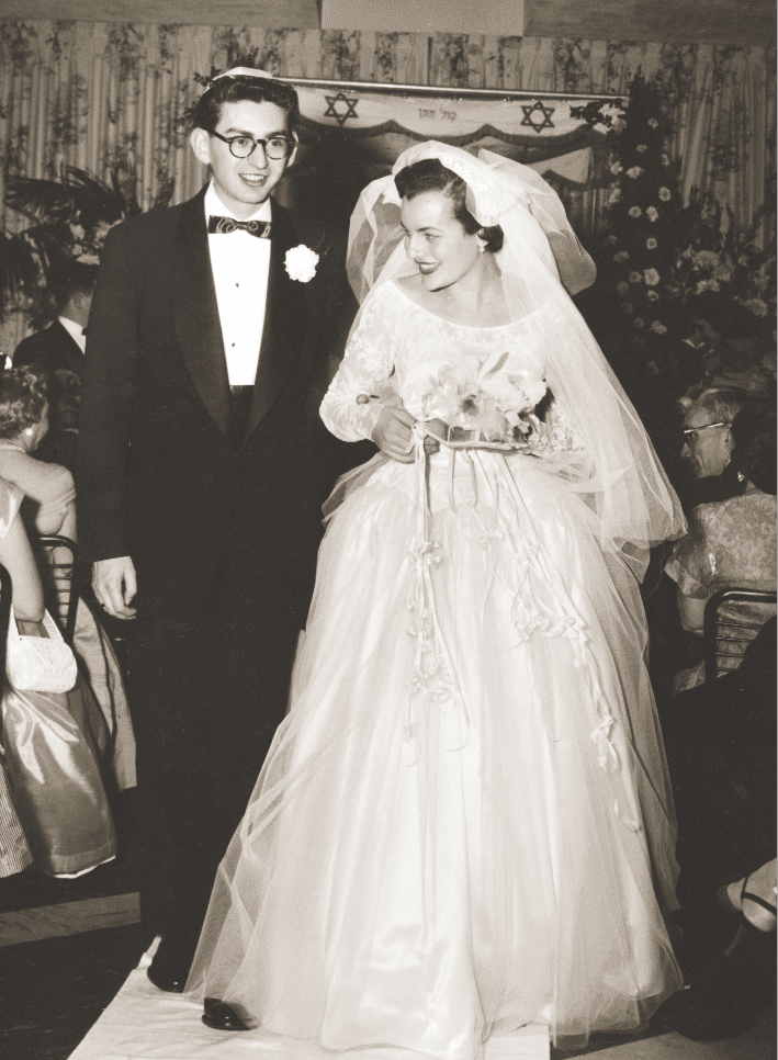 EB and ELB walkingdown aisle at wedding